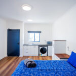 the goldminer accessible studio apartment full view of internal space including kitchenette and laundry